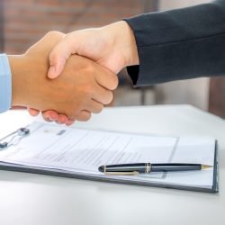 handshake after Office executives interviewing job applicants in handshake after Office executives interviewing job applicants in the meeting room. employer conversation summary work employment.